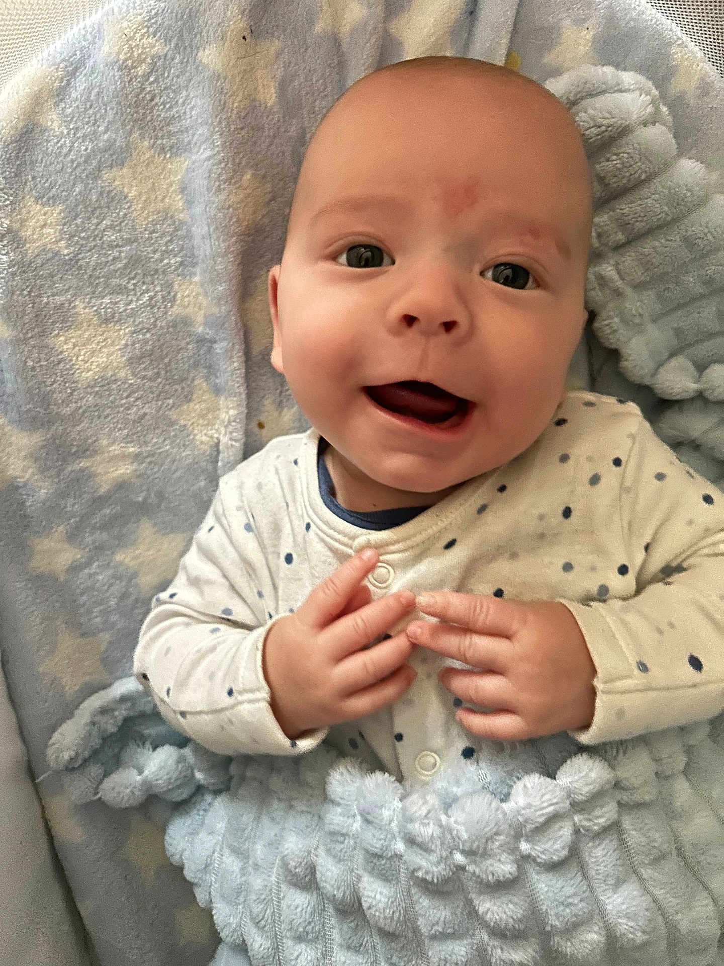 Keegan is registered to the contest to win money with this photo: baby, infant, smile, face, hands, blanket, clothing, dots, cozy, soft, texture, pattern, star_pattern, happy, cute, child, portrait, indoor, newborn, warm