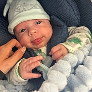 Keegan joined the competition — help win amazing prizes! baby, infant, hat, blanket, hand, smile, tongue, cute, clothing, dumbo, snuggled, soft, fluffy, portrait, closeup, child, newborn, face, person, cozy