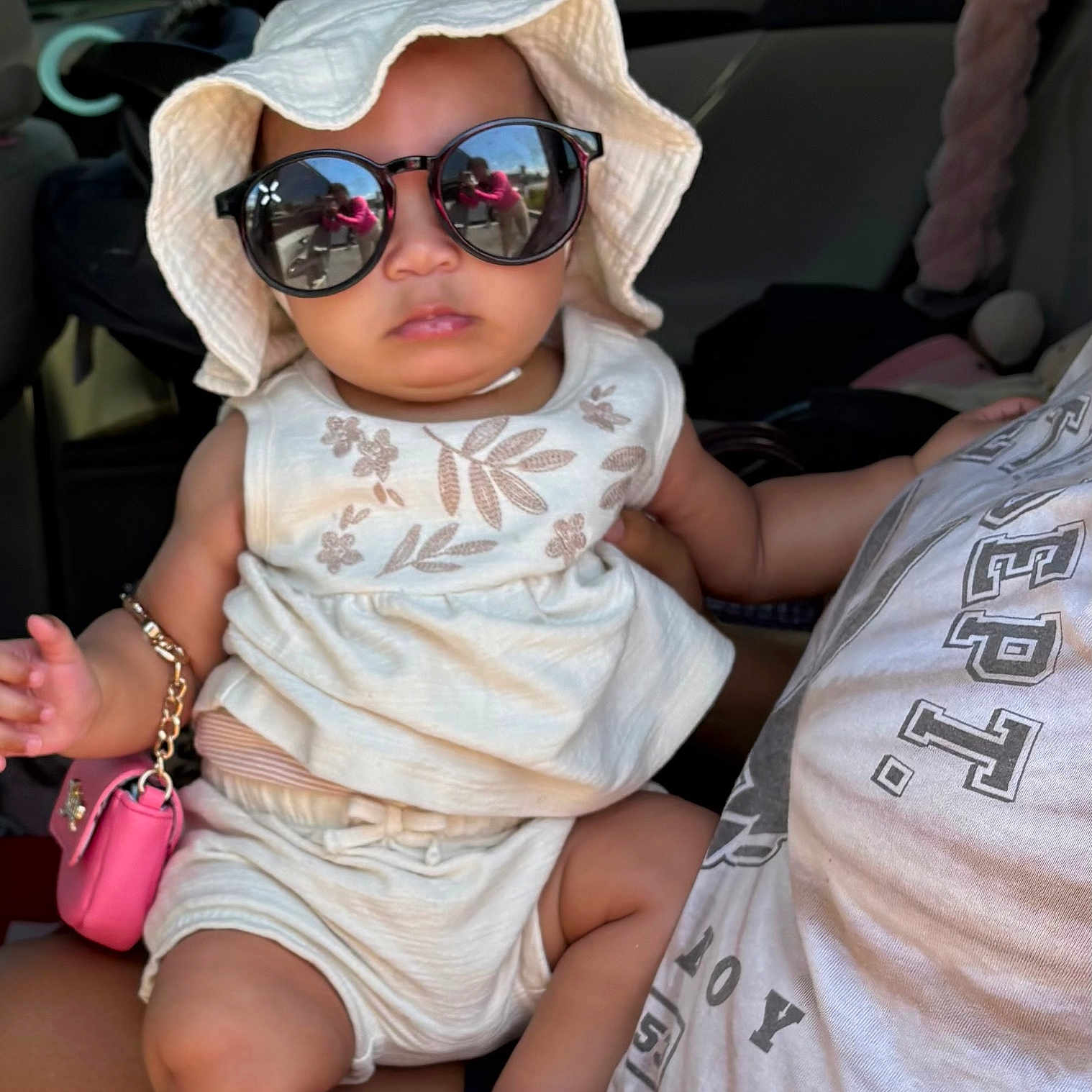Jasmine joined the competition — help win amazing prizes! accessory, baby, car_interior, casual, child, clothing, cute, fashion, funny, hat, holding, infant, person, pink_purse, portrait, reflection, seat, summer, sunglasses, young