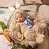 baby, newborn, sleeping, portrait, bunny_hat, knitwear, bow_tie, carrots, basket, furry_blanket, curly_texture, rustic_background, stone_floor, cozy, infant, peaceful, still_life, themed_photography, winter_clothing, cute