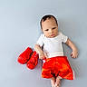 Giovanni joined the competition — help win amazing prizes! baby, infant, child, boxing_gloves, boxing, red_shorts, white_shirt, lying_down, portrait, face, person, 赤, studio_photo, blue_background, costume, sports_theme, hands, feet, indoor, cute