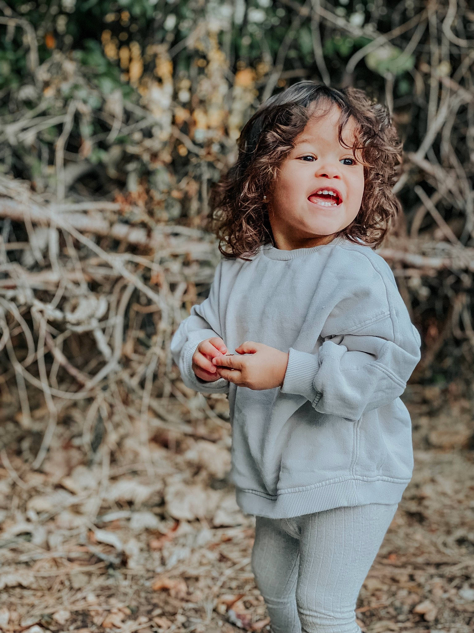 Ella Grace joined the competition — help win amazing prizes! blond, branch, child, flash_photography, forest, gesture, grass, hair, happy, lip, people_in_nature, person, plant, skin, sleeve, smile, toddler, tree, twig, wood