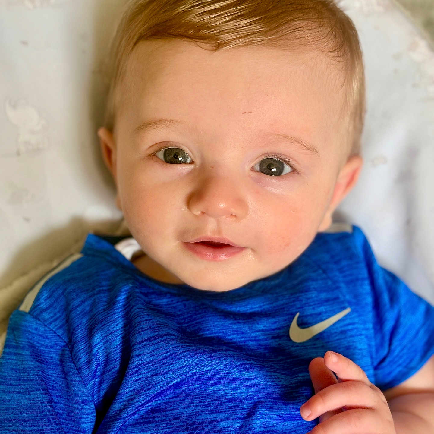 Oakley joined the competition — help win amazing prizes! baby, blue_shirt, child, clothing, cute, eyes, face, hand, indoor, infant, light, nike_logo, patterned_blanket, person, portrait, skin, smile, soft_light, toddler, young_child