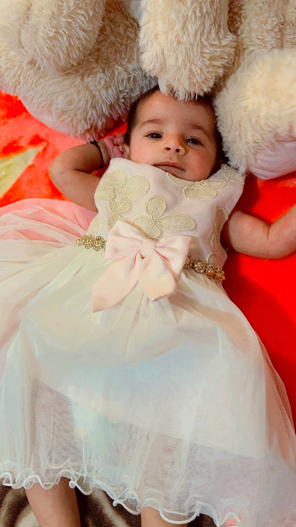 Aradhana is registered to the contest to win money with this photo: baby, baby_toddler_clothing, bridal_accessory, child, dress, embellishment, event, face, gown, happy, headgear, headpiece, iris, peach, person, pink, skin, textile, toddler, wedding_ceremony_supply
