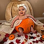 baby, pumpkin, headband, teddy_bear, blanket, autumn_leaves, small_pumpkins, mushrooms, indoor, cute, smiling, child, fall, decor, cozy, sitting, soft_toy, orange, white_blanket, playful