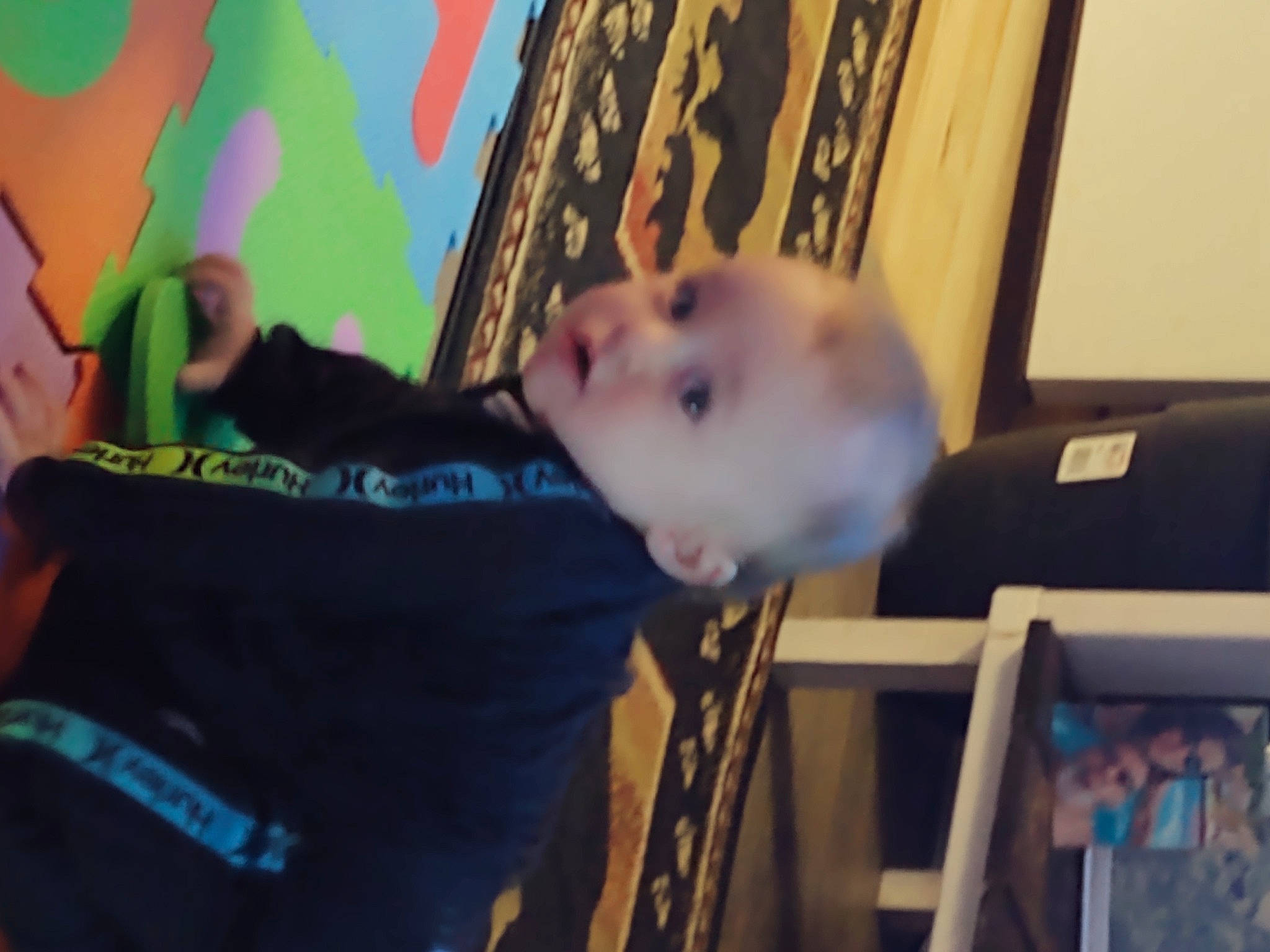 Maddox is registered to the contest to win money with this photo: art, baby, blurred, child, flooring, fun, happy, human_body, leisure, pattern, person, play, room, surprise, t_shirt, toddler, tree, under_exposed, visual_arts