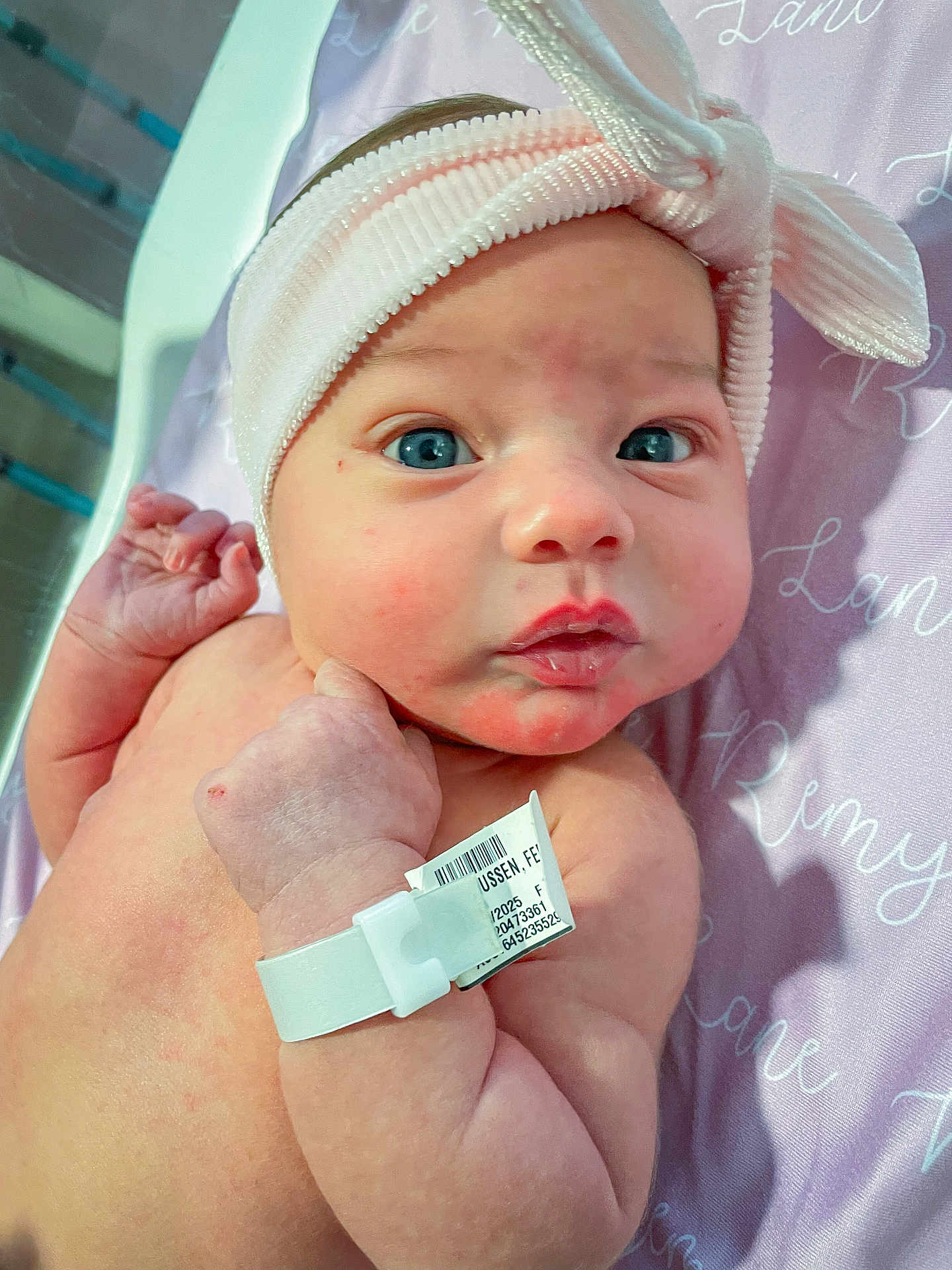 Remy is registered to the contest to win money with this photo: architecture, baby, bed, bodypart, bonnet, building, cap, clothing, face, finger, glove, hand, hat, head, hospital, newborn, person, photography, portrait, text