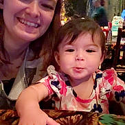 Skylar joined the competition — help win amazing prizes! child, toddler, woman, smiling, happy, table, indoor, person, face, clothing, pattern, hand, hair, portrait, family, dining, cute, casual, people, restaurant