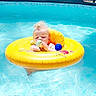 Mateo joined the competition — help win amazing prizes! baby, baby_toy, blue, child, childhood, cute, floating, fun, infant, inflatable_ring, outdoor, playful, pool, relaxing, summer, sunlight, swimming_pool, toy, water, yellow
