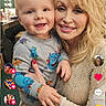Mattie joined the competition — help win amazing prizes! baby, child, woman, adult, smiling, portrait, indoor, dressing_room, vanity_lights, curtains, blonde_hair, colorful_clothing, cartoon_print, holding, sitting, happy, faces, social_media, screenshot, photography