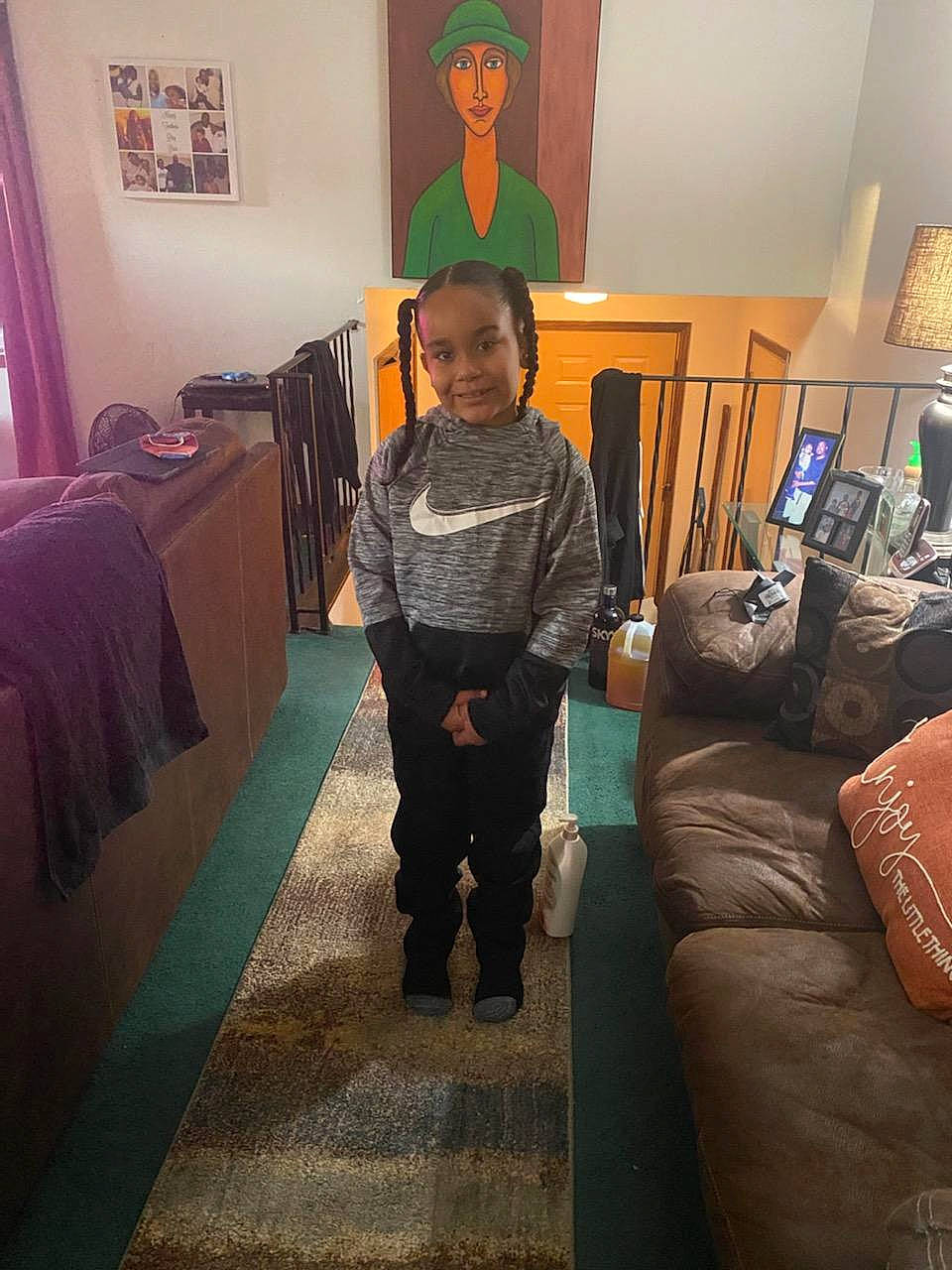 Javon is registered to the contest to win money with this photo: art, bedroom, boot, carpet, comfort, couch, floor, flooring, hardwood, joy, lamp, living_room, person, picture_frame, pillow, room, standing, t_shirt, television, textile