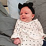 Aurora joined the competition — help win amazing prizes! baby, infant, child, headband, bow, polka_dot, white_clothing, blue_pants, bed, pillow, gray_pillow, striped_pillow, fabric, smile, indoor, cute, relaxed, person, young, portrait