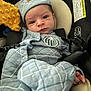 Charlie joined the competition — help win amazing prizes! baby, infant, newborn, car_seat, quilted_blanket, hat, onesie, seat_belt, buckle, plush_toy, yellow_toy, warning_label, close_up, portrait, gaze, hand, soft_texture, blue_clothing, seat_padding, indoors