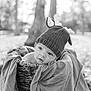 baby, infant, knit_hat, basket, blanket, portrait, black_and_white, outdoors, trees, bokeh, cute, cozy, hat, face, eyes, expression, texture, woven, soft, pose