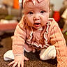 Elsie-Mae is registered to the contest to win money with this photo: baby, child, pink_bow, headband, crawling, carpet, sweater, knitwear, indoor, cute, infant, expression, hand, face, portrait, young_child, curious, clothing, floor, person
