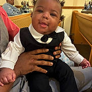 Akari joined the competition — help win amazing prizes! adult, baby, bench, bow_tie, child, clothing, cushion, cute, hair_buns, hand, indoor, mirror, person, portrait, reflection, seated, smile, socks, toddler, tuxedo