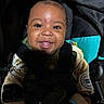 Akari joined the competition — help win amazing prizes! baby, bottle, car_seat, child, closeup, clothing, cute, dark_background, face, happy, indoors, infant, jacket, patch, person, portrait, seatbelt, sitting, smiling, young_child