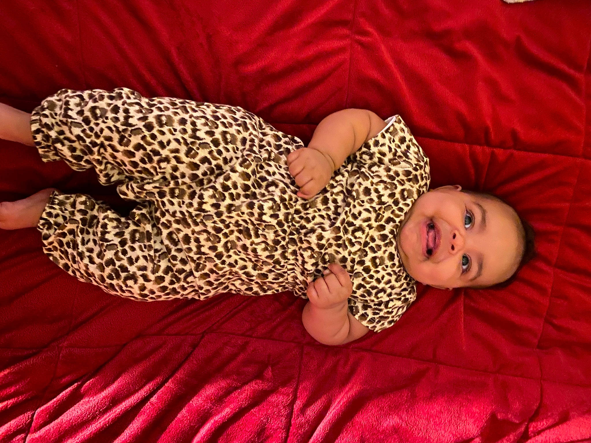 Tru is registered to the contest to win money with this photo: baby, baby_sleeping, baby_toddler_clothing, bedding, child, comfort, fawn, finger, flooring, hand, headgear, human_body, human_leg, joy, leg, linens, pattern, person, pink, red