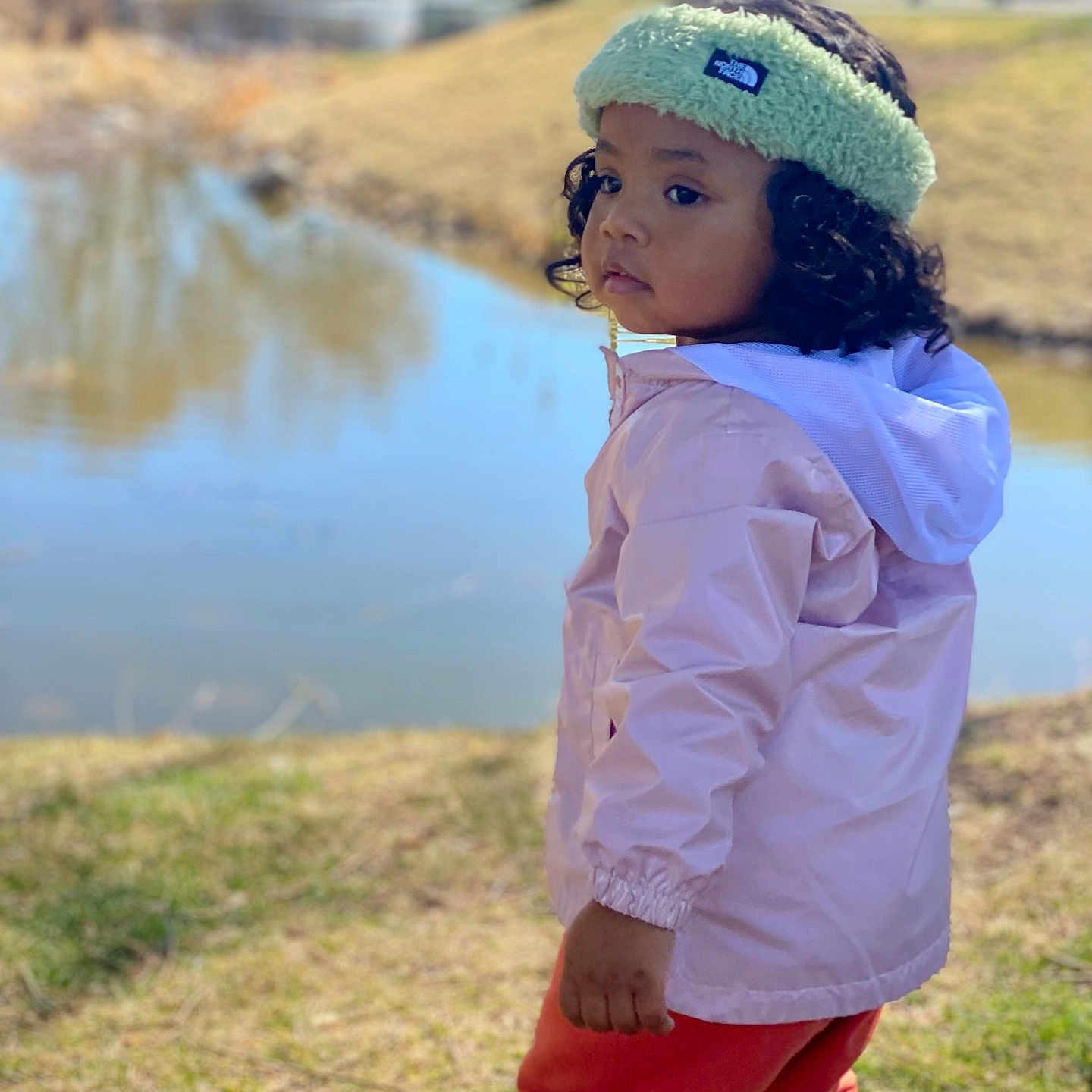 Kalifia joined the competition — help win amazing prizes! beanie, cap, child, clothing, coat, face, female, girl, grass, hat, head, jacket, nature, outdoors, pants, person, photography, plant, portrait, water