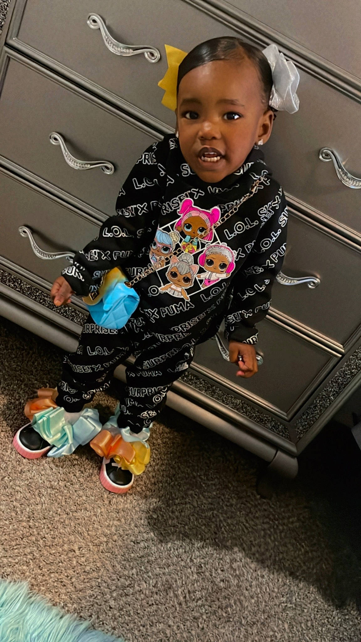 Dariyah is registered to the contest to win money with this photo: baby, baby_toddler_clothing, child, fashion_accessory, flooring, fun, gadget, happy, magenta, metal, pattern, person, pink, play, room, sitting, sleeve, sock, standing, t_shirt
