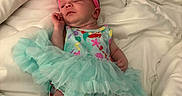 Skylar Marcella joined the competition — help win amazing prizes! baby, blanket, blue, bow, clothing, colorful, cute, dress, footwear, headband, infant, newborn, person, pink, portrait, resting, sleeping, soft, tutu, white