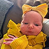 Skylar Marcella is registered to the contest to win money with this photo: baby, blanket, bow, child, closeup, couch, cozy, cute, face, hand, headband, indoor, infant, newborn, person, portrait, resting, skin, soft_light, yellow_clothing
