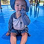 toddler, child, baby, sitting, blue, hat, swimwear, water, pool, outdoor, sunny, chewing, clothing, people, reflection, legs, barefoot, playing, summer, daytime