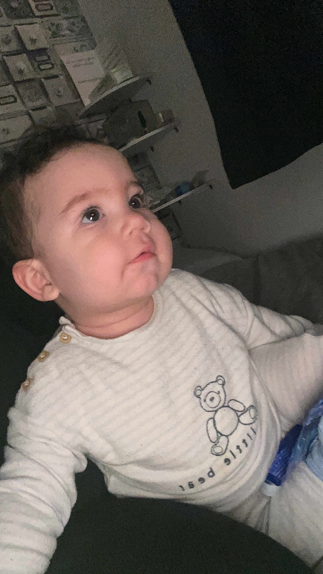 Bailey joined the competition — help win amazing prizes! baby, child, indoor, onesie, teddy_bear, striped_clothing, face, curious, sitting, furniture, shelf, wall_decor, soft_lighting, portrait, young_child, cute, infant, person, home, cozy