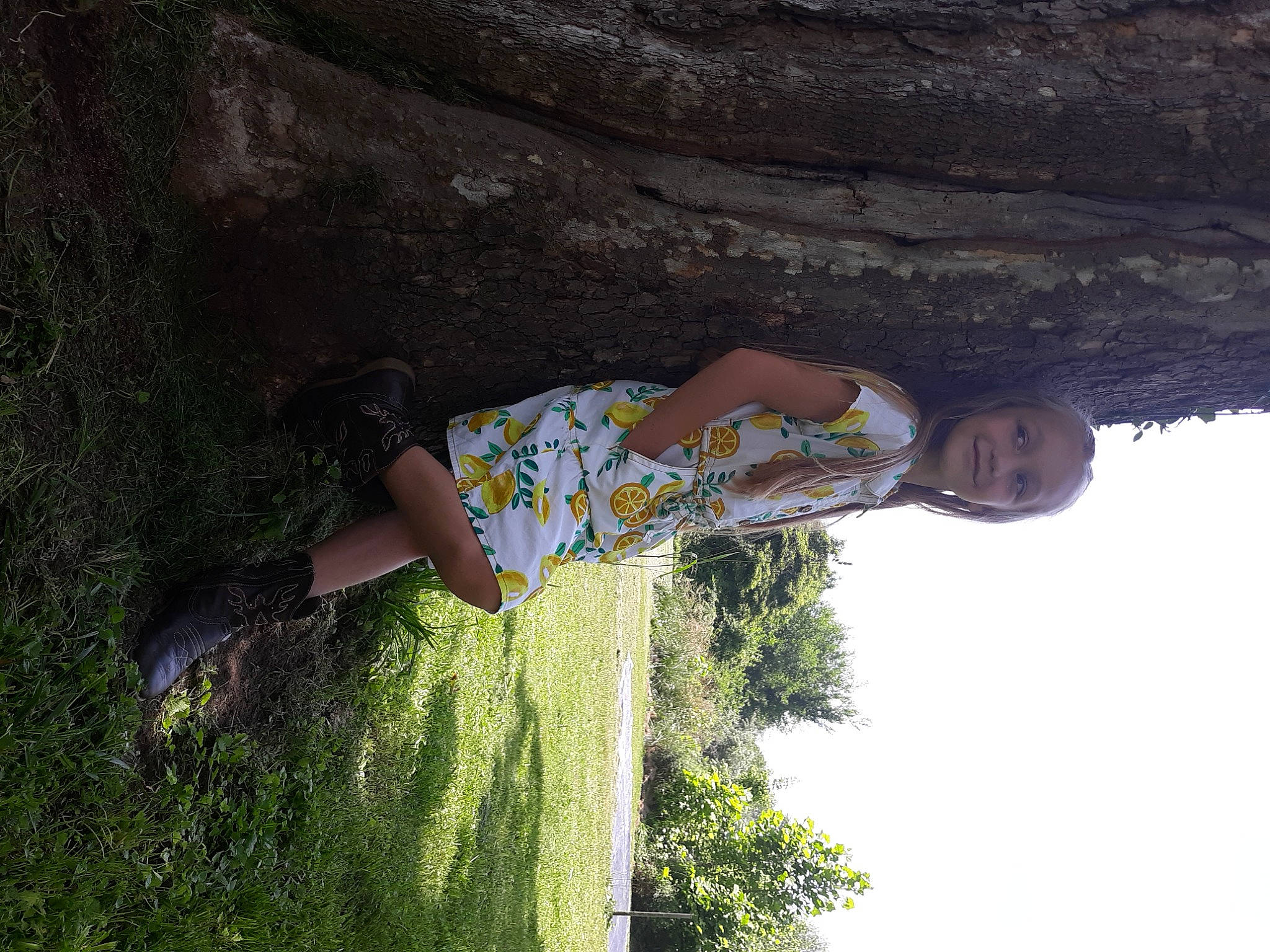 Kenleigh is registered to the contest to win money with this photo: adventure, elbow, fun, grass, happy, joy, landscape, leisure, people_in_nature, person, plant, recreation, rock, shadow, sky, t_shirt, thigh, tints_and_shades, tree, trunk