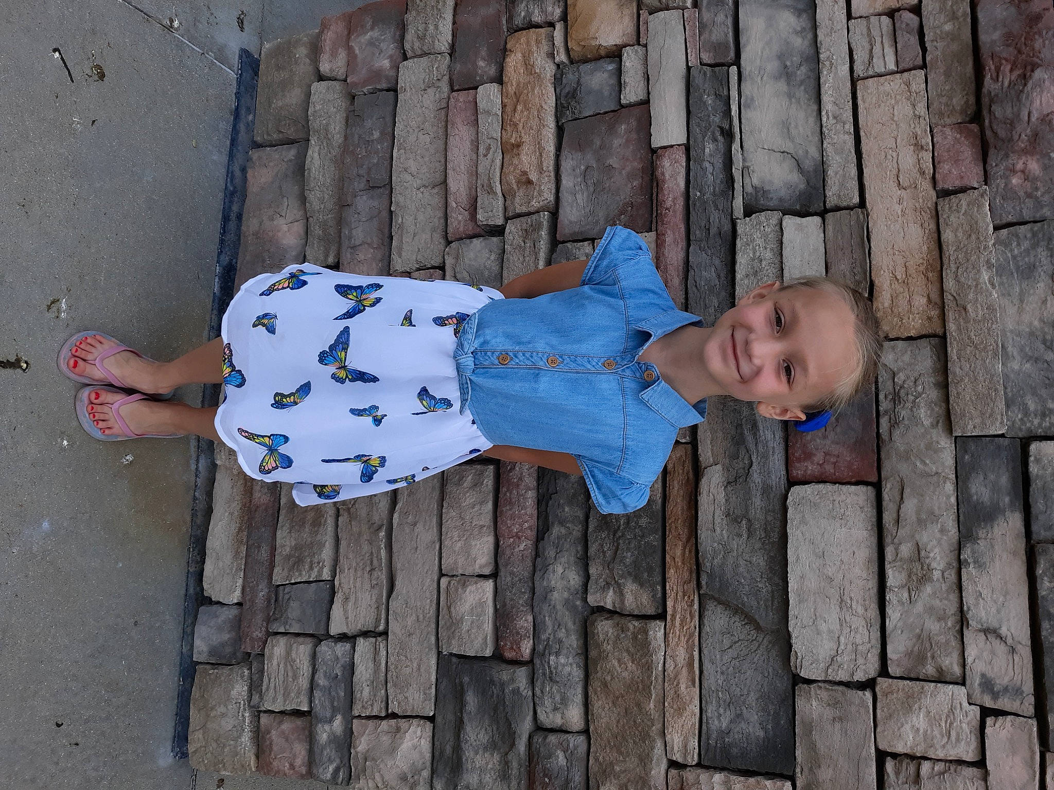 Kenleigh is registered to the contest to win money with this photo: azure, baby_toddler_clothing, child, concrete, electric_blue, flooring, foot, fun, human_body, human_leg, joy, line, pattern, person, red, road_surface, sidewalk, sleeve, thigh, toddler