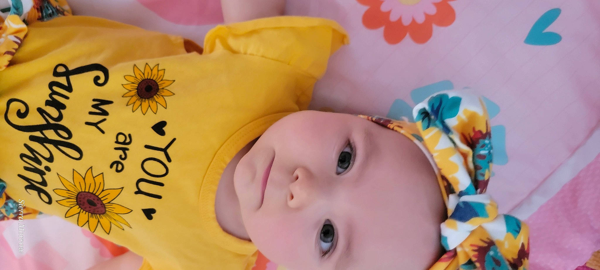 Evelyn is registered to the contest to win money with this photo: baby, baby_toddler_clothing, beauty, cheek, eye, eyebrow, eyelash, face, facial_expression, happy, head, headwear, iris, nose, person, petal, product, skin, textile, toddler