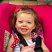 Addison joined the competition — help win amazing prizes! toddler, child, car_seat, pink, smiling, curly_hair, sippy_cup, seatbelt, red_bow, polka_dots, white_dress, happy, portrait, baby, cute, indoors, closeup, person, seat, safety