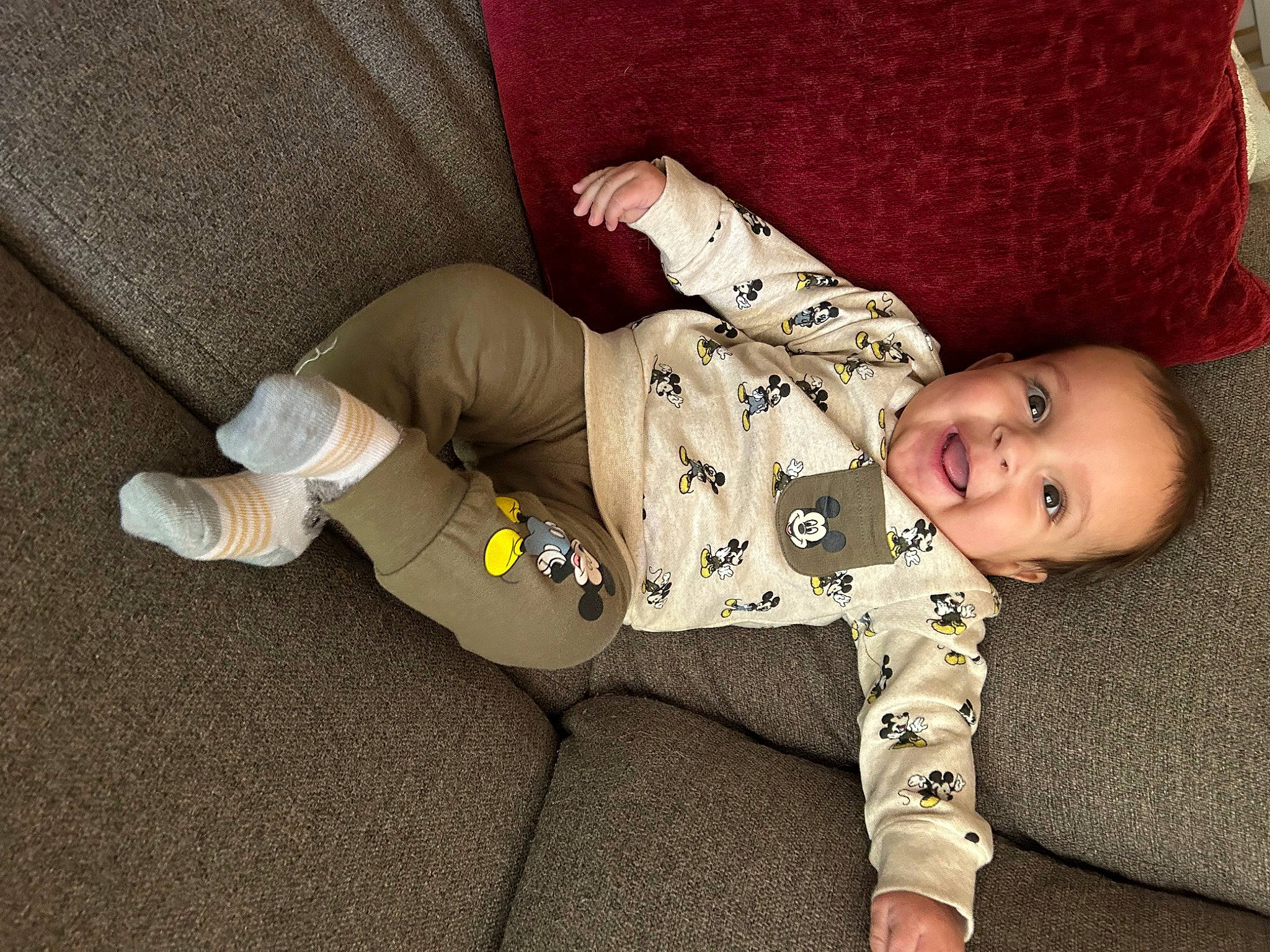 Stephen is registered to the contest to win money with this photo: baby, baby_toddler_clothing, carmine, cheek, child, comfort, floor, flooring, foot, human_body, human_leg, joy, knee, leg, pattern, person, sitting, skin, sleeve, smile