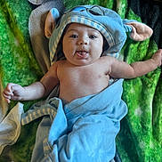 Maeve joined the competition — help win amazing prizes! baby, infant, blue_towel, animal_hood, tongue_out, green_blanket, cute, playful, child, smiling, skin, soft_lighting, lying_down, chubby_cheeks, expression, cozy, blanket, wrapped, headwear, adorable