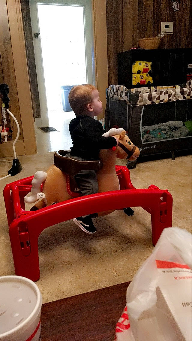 Nicholas is registered to the contest to win money with this photo: ankle, baby, baby_products, baby_toddler_clothing, baby_toys, child, comfort, human_body, lamp, lap, person, plastic, play, shelf, sitting, stuffed_toy, toddler, toe, toy