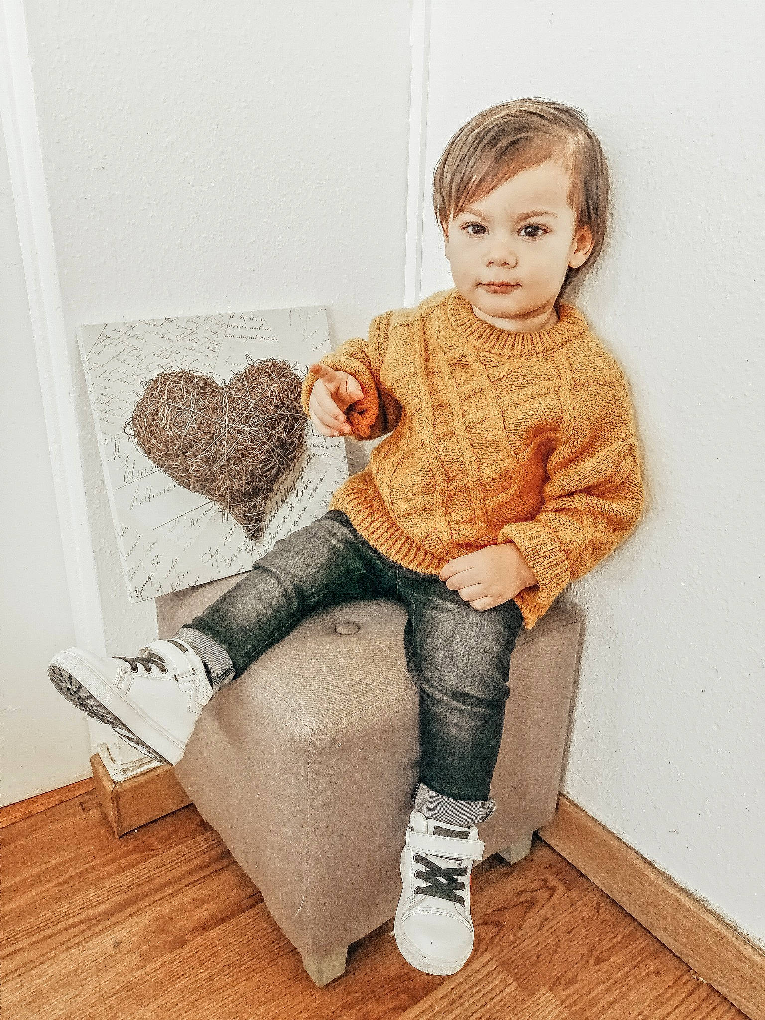 Owen participe au concours pour gagner de l'argent avec cette photo : baby_toddler_clothing, beige, clothing, denim, floor, flooring, human, human_body, jeans, knitting, laminate_flooring, leg, living_room, sitting, sleeve, sock, sweater, textile, wood_flooring, wool