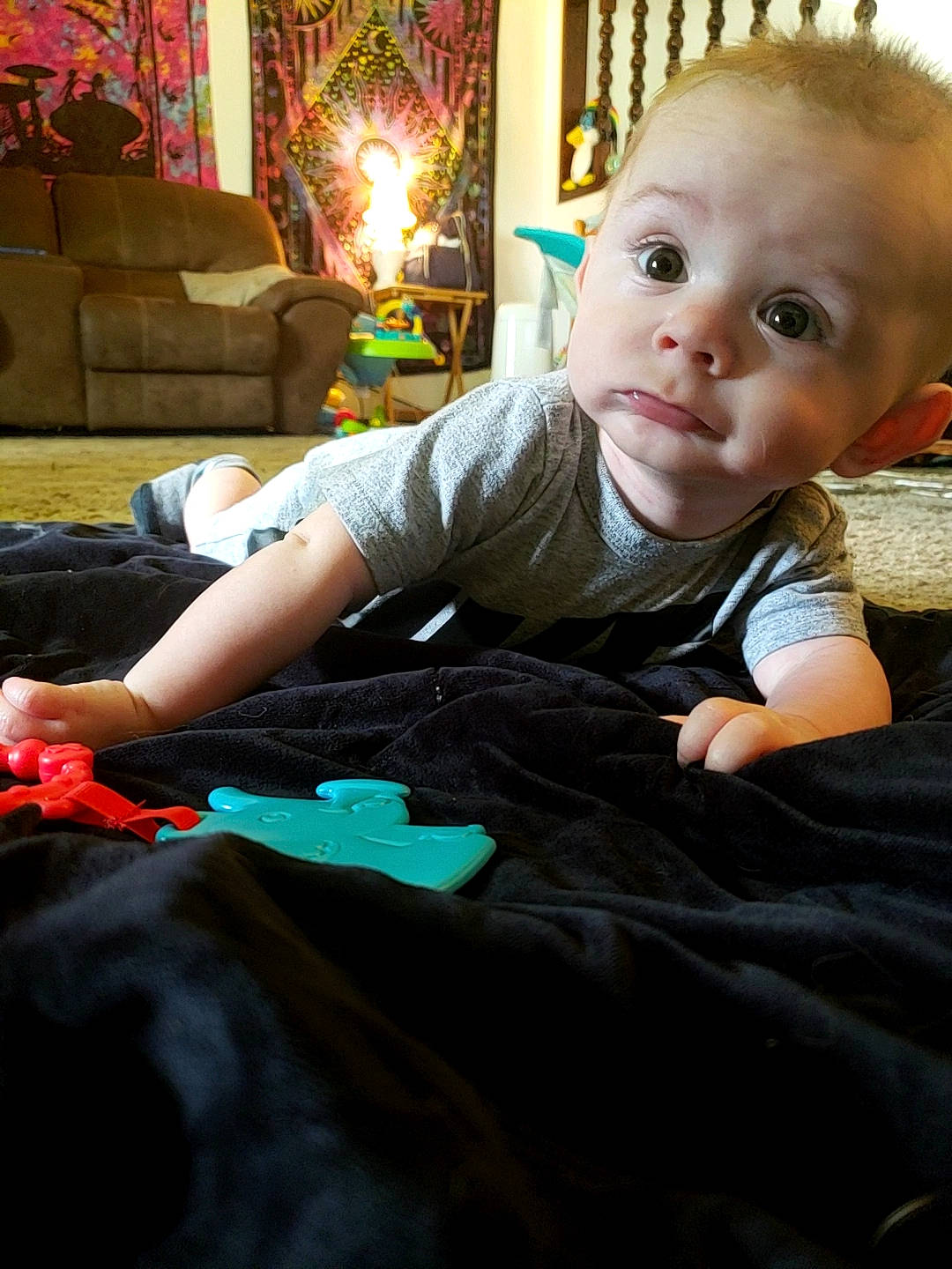 Creed is registered to the contest to win money with this photo: baby_toddler_clothing, cheek, child, comfort, eye, face, flash_photography, flooring, fun, happy, head, human_body, lamp, lap, living_room, person, sitting, skin, sleeve, toddler