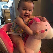 Kaiya is registered to the contest to win money with this photo: baby, carpet, child, colorful, cute, face, fun, furniture, happy, home, indoor, person, play, plush_toy, rocking_horse, seat, smiling, toddler, toy, wood