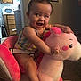 baby, carpet, child, colorful, cute, face, fun, furniture, happy, home, indoor, person, play, plush_toy, rocking_horse, seat, smiling, toddler, toy, wood