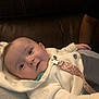 Kaiya is registered to the contest to win money with this photo: baby, child, clothing, comfort, cozy, cute, expression, face, hand, indoor, infant, leather_sofa, pacifier_clip, person, portrait, relaxing, smile, soft_lighting, white_sweater, young