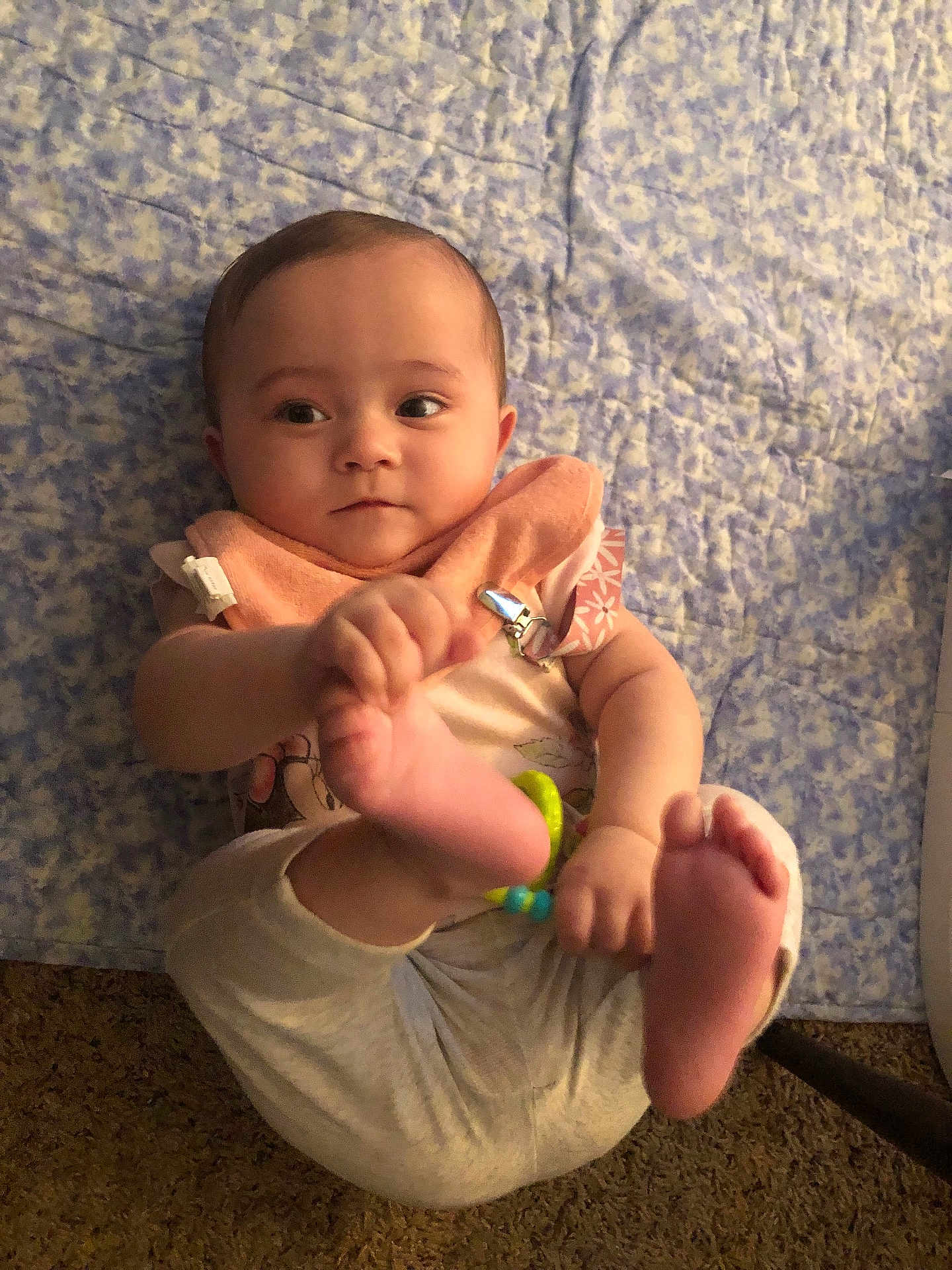 Kaiya is registered to the contest to win money with this photo: baby, infant, child, playful, feet, blanket, blue, clothing, bib, indoor, cute, curious, person, human, skin, hand, foot, carpet, toy, relaxed
