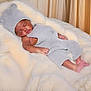 baby, sleeping, knit_hat, knit_outfit, gray_clothing, infant, cozy, blanket, white_blanket, soft_texture, cute, peaceful, resting, newborn, child, indoors, portrait, small_feet, adorable, furry_surface