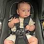 baby, child, stroller, seatbelt, harness, infant, clothing, footwear, cute, sitting, indoor, person, face, skin, head, legs, expression, socks, safety, transport