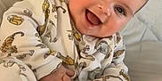 Matteo joined the competition — help win amazing prizes! baby, infant, pajamas, animal_print, smiling, drool, hand, foot, sock, bed, blanket, cozy, cute, child, portrait, indoors, soft_light, happy, young, person