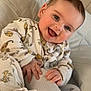 baby, infant, pajamas, animal_print, smiling, drool, hand, foot, sock, bed, blanket, cozy, cute, child, portrait, indoors, soft_light, happy, young, person