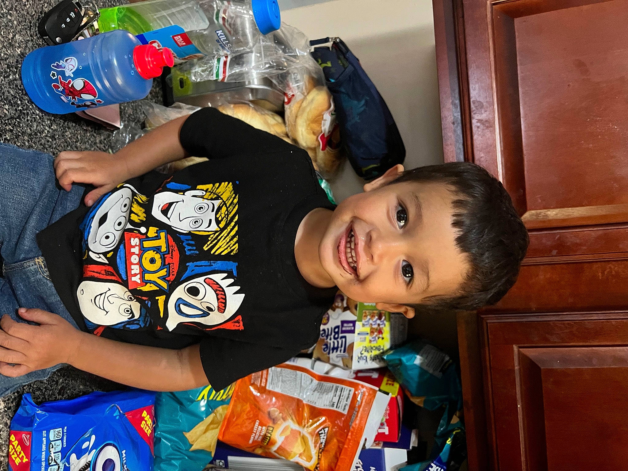 Aidan joined the competition — help win amazing prizes! bottled_water, child, drinking_water, event, fun, happy, joy, person, plastic, plastic_bottle, room, smile, t_shirt, toddler, water_bottle