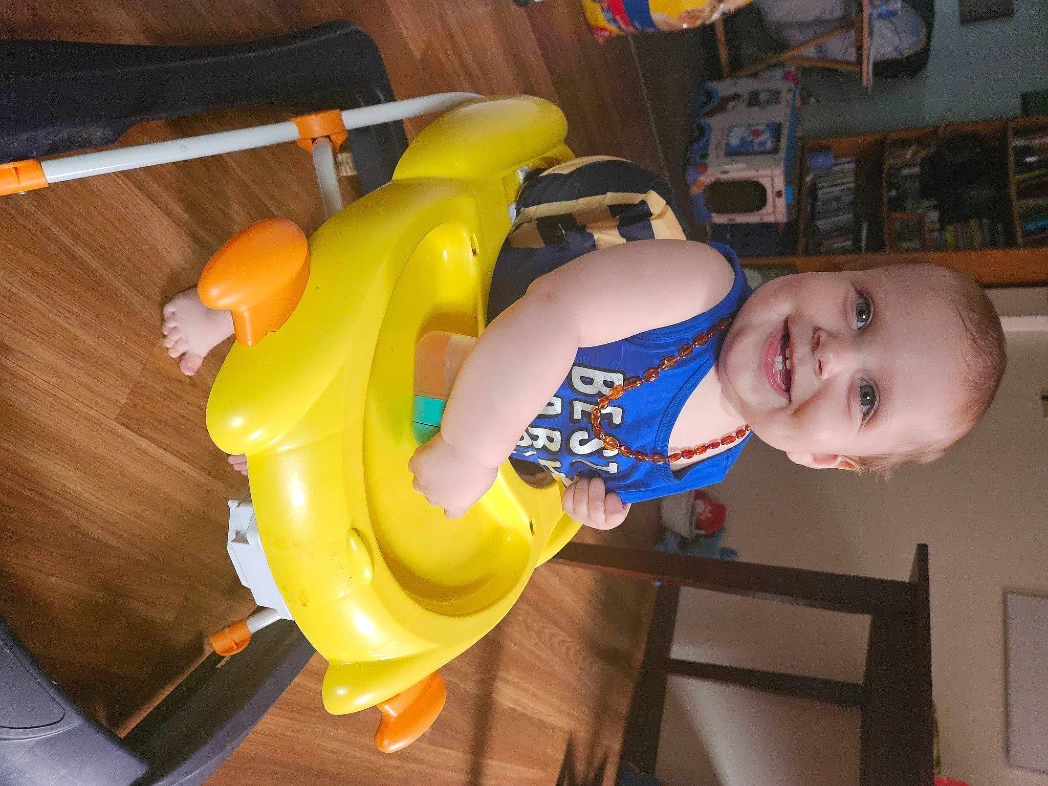 Jasper is registered to the contest to win money with this photo: baby_toddler_clothing, child, elbow, electric_blue, fun, joy, leisure, person, plastic, play, recreation, room, shelf, smile, t_shirt, thigh, toddler, toy, wood