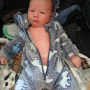 Orion joined the competition — help win amazing prizes! baby, infant, child, portrait, sitting, couch, blanket, fleece, hoodie, blue_clothing, animal_print, face, eyes, hands, legs, indoors, home, cozy, cute, photography