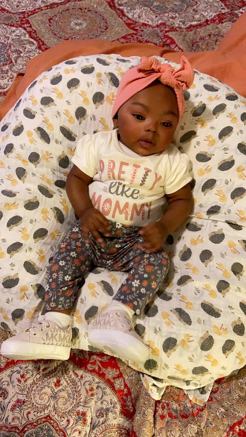 Mylah is registered to the contest to win money with this photo: baby, baby_toddler_clothing, cap, child, comfort, event, flooring, fun, happy, hat, linens, pajamas, pattern, person, play, room, sitting, t_shirt, textile, thigh