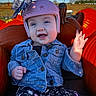 baby, child, smiling, waving, helmet, pink_helmet, denim_jacket, jacket, pumpkin_patch, pumpkins, outdoor, autumn, fall, blue_sky, portrait, sitting, infant, happy, patterned_pants, farm